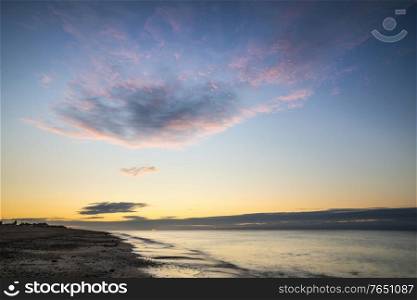 Stunning vibrant sunrise over beach landscape on English South coast