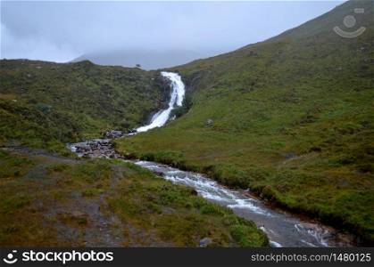 Stunning view of a rishing waterfall in Skye, Scotland