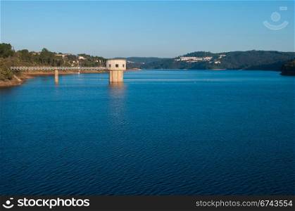 stunning view of river Zezere and Castelo de Bode Dam in Tomar, Portugal (gorgeous blue sky)