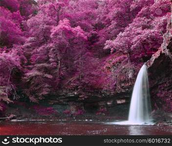 Stunning waterfall in alternate surreal colored landscape
