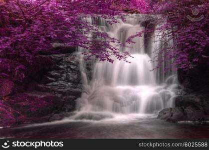 Stunning waterfall in alternate surreal colored landscape