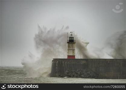 Stunning waves crashing over harbor wall during windy storm at Newhaven on English coast