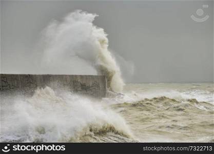 Stunning waves crashing over harbor wall during windy storm at Newhaven on English coast