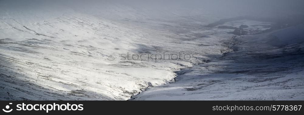 Stunning Winter panorama landscape snow covered countryside with beautiful sky and clouds