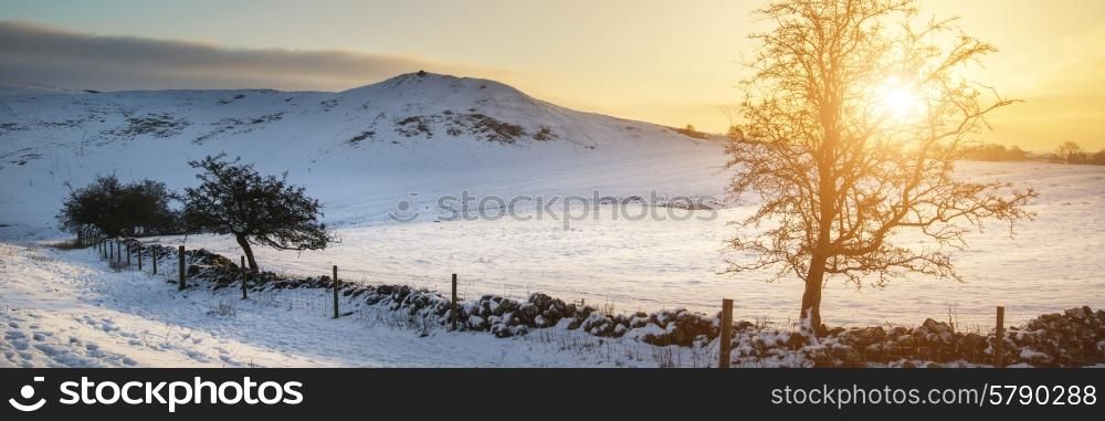 Stunning Winter panorama landscape snow covered countryside with beautiful sky and clouds