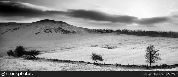 Stunning Winter panorama landscape snow covered mountain in black and white