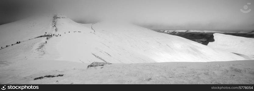 Stunning Winter panorama landscape snow covered mountains in black and white