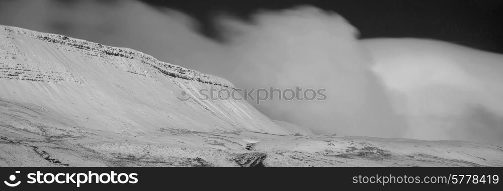 Stunning Winter panorama landscape snow covered mountains in black and white