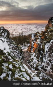 Stunning Winter sunset landscape from mountains looking over countryside