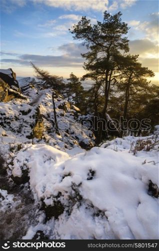 Stunning Winter sunset landscape from mountains looking over countryside