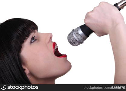 Stunning woman singing into a microphone