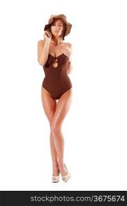 stunning young woman wearing a brown swimsuit and a summer hat posing