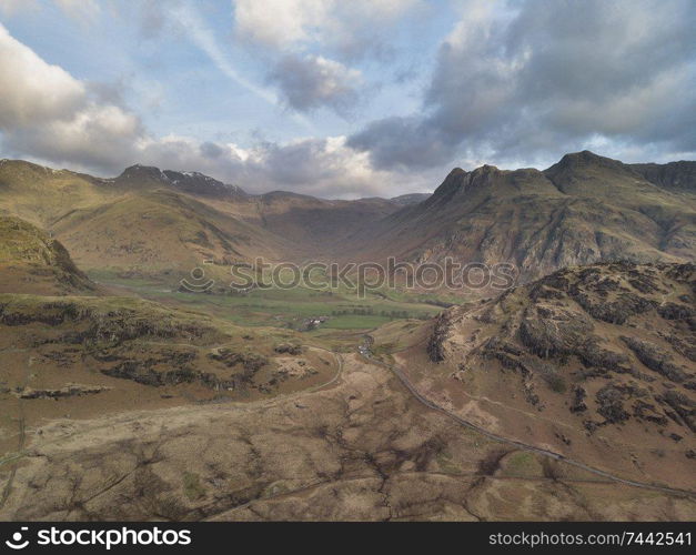 Stunnnig drone aerial sunrise landscape image of Blea Tarn and Langdales Range in UK Lake District