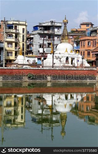Stupa and buildings near pond in Patan, Nepal