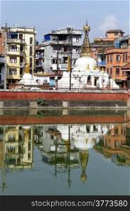Stupa and buildings near pond in Patan, Nepal