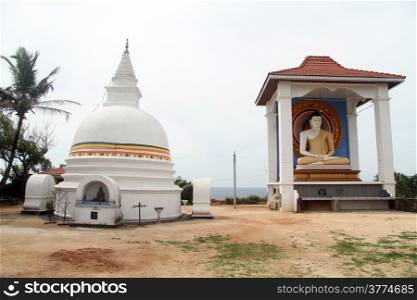 Stupa and seated Buddha in monastery in Unawatuna, Sri Lanka