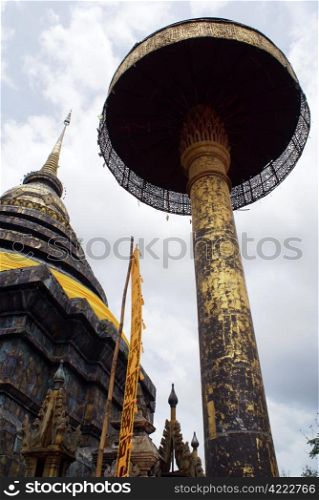 Stupa and umbrella in Wat Phra That Lampang Luang, Lanna Thai, Thailand