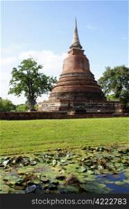 Stupa in wat Mahathat and lotus pond in old Sukhotai, Thailand