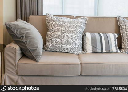 Sturdy brown tweed sofa with grey patterned pillows