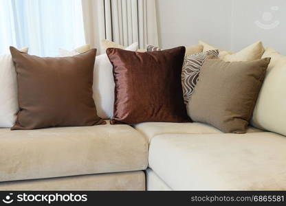 Sturdy brown tweed sofa with grey patterned pillows