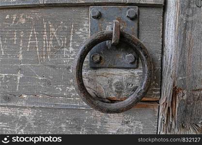 Sturdy iron ring on old wooden door