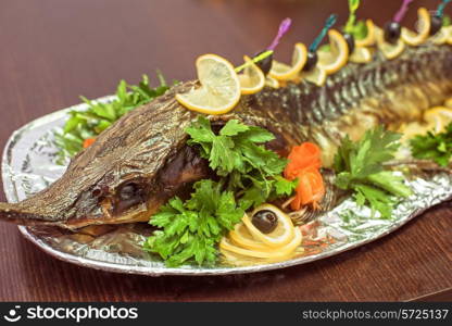 sturgeon baked with greens fruits and vegetables