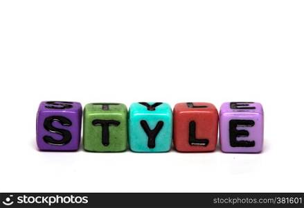 style - word made from multicolored child toy cubes with letters