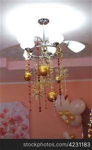 stylish beautiful chandelier decorated with christmas bulbs
