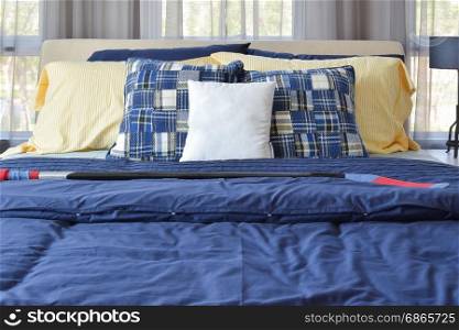 stylish bedroom interior design with blue patterned pillows on bed