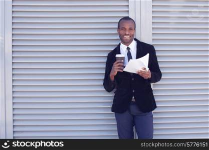 stylish black man documents handling outdoors