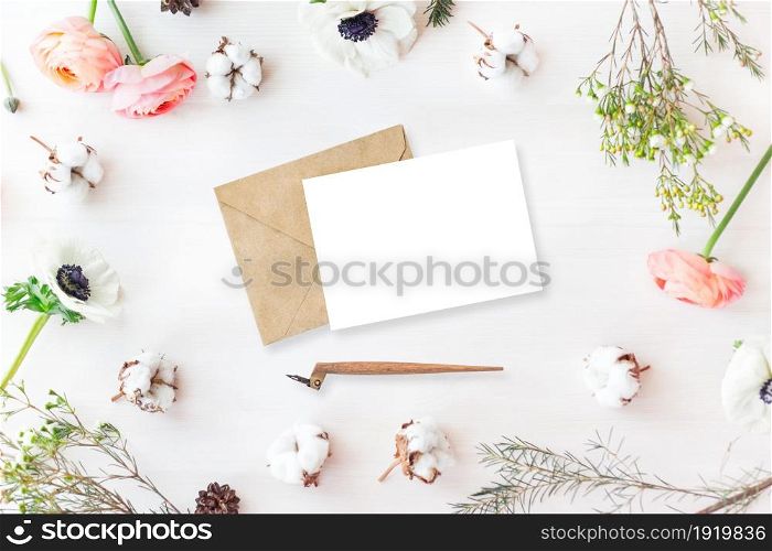 Stylish branding mockup to display your artworks. Cute vintage mock up on wooden background. Flat lay top view.. Cute and stylish branding mockup photo wit flowers.