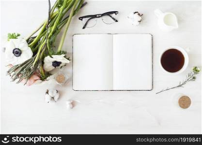 Stylish branding mockup to display your artworks. Cute vintage mock up on wooden background. Flat lay top view.. Cute and stylish branding mockup photo wit flowers.