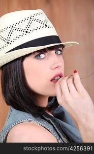 Stylish brunette wearing straw hat