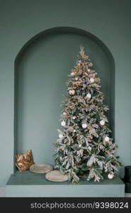 Stylish Christmas tree with pillows next to it in mint color