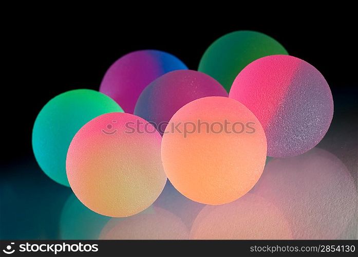 Stylish colorful balls with reflection. Isolated on black background