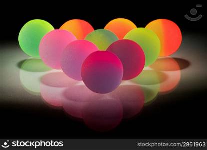 Stylish colurful balls with reflection. Isolated on black background