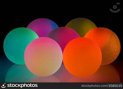 Stylish colurful balls with reflection. Isolated on black background