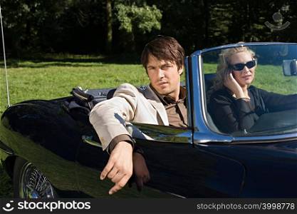 Stylish couple in convertible