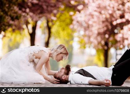 stylish couple lying on the ground in old town in spring. couple having fun together on urban background. couple enjoying spring. stylish couple lying on the ground in old town in spring. couple having fun together on urban background. couple enjoying spring.