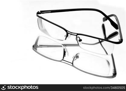 stylish eyeglasses on white mirror surface