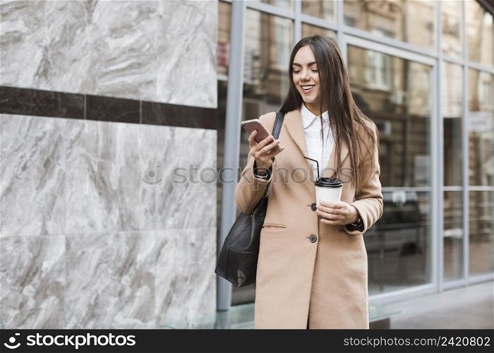 stylish girl with coffee phone outside