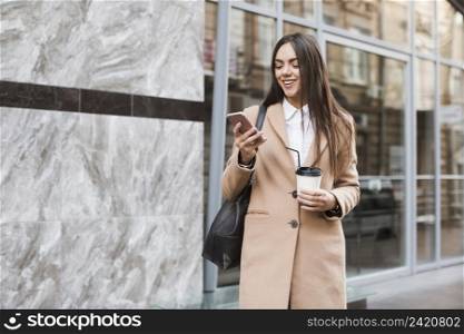stylish girl with coffee phone outside