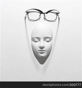 Stylish glasses with black frame or reading daily life on a gypsum face sculpture on a white background, soft long shadows, place for text. Flat lay. Plaster face mask with elegant glasses above it on a white background with soft long shadows, copy space. Flat lay.