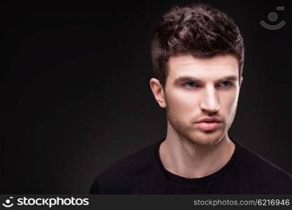 Stylish guy close up portrait on black background