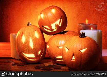 Stylish Halloween decorations, carved pumpkins with scary faces and candles as decor for Halloween party, traditional autumn holiday