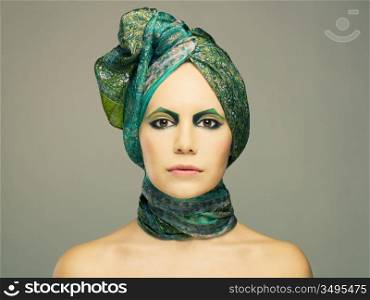 Stylish lady in green turban with bright make-up
