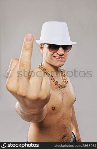 Stylish man in white hat showing middle finger