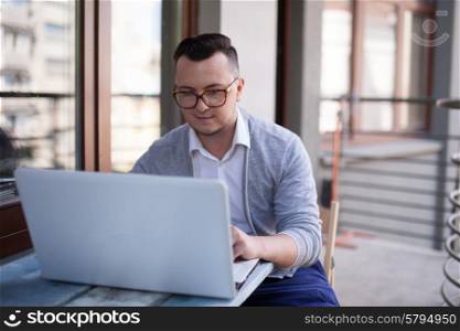 Stylish Man using laptop in startup office outdoors