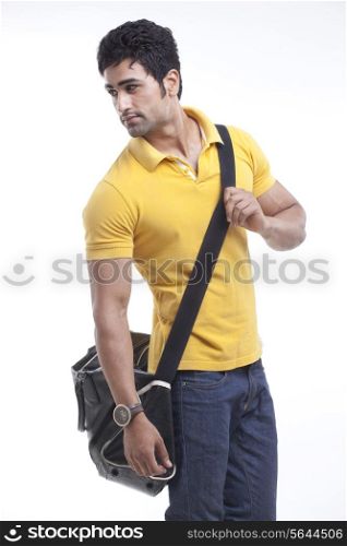 Stylish man with duffle bag looking away