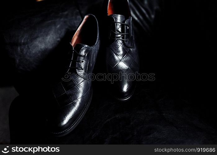 Stylish men's shoes on a table on a dark wooden background. men's shoes on a dark background. men's shoes on a dark background. Stylish men's shoes on a table on a dark wooden background
